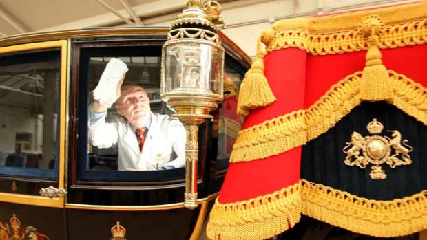 Carriage restorer Dave Evans cleans the windows of the Glass Coach at the Royal Mews in central London in preparation for Prince William's wedding.