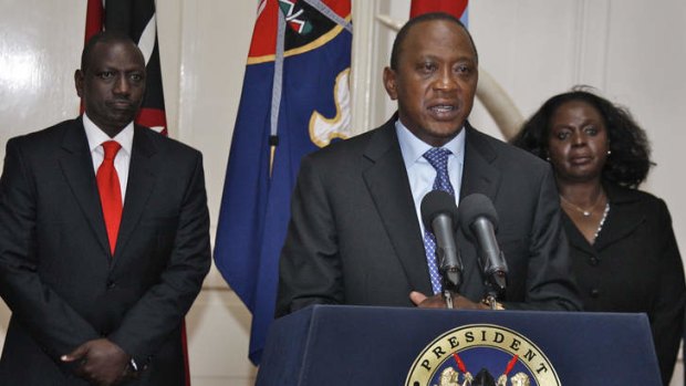 Kenyan President Uhuru Kenyatta, centre, makes a television address to the nation saying security forces have finally defeated a small group of terrorists after four days of fighting at Nairobi's Westgate mall.