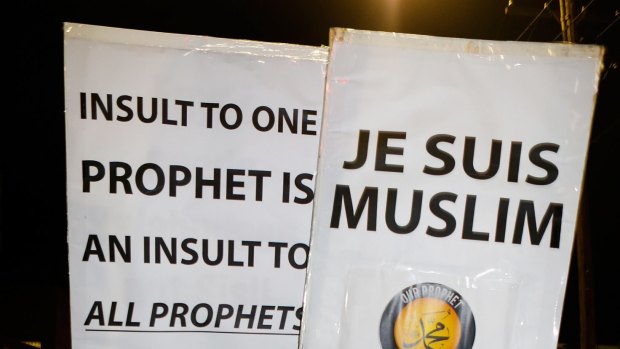 Children hold placards during the rally to show their support for the Prophet Muhammad.