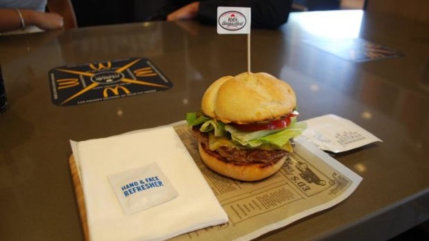 The fancy burgers are served on a wooden board, a concept popular in trendy burger bars.