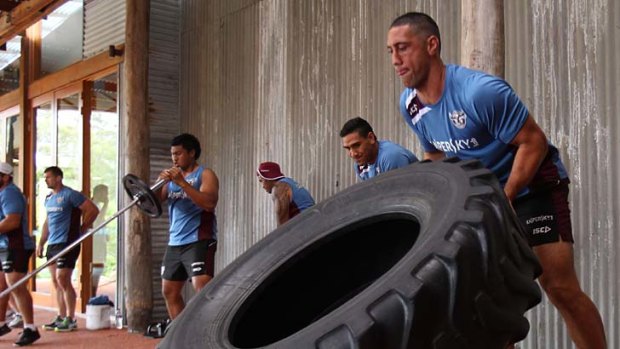 No pain, no game ... veteran prop Brent Kite, with tractor tyre, shows his younger Manly teammates the way at a training camp on the central coast during the week.