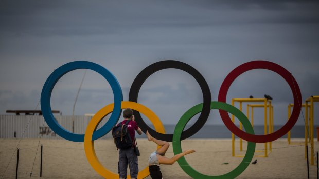 Visitors take photographs in front of the Olympic Rings at Copacabana beach in Rio de Janeiro during the 2016 Games.