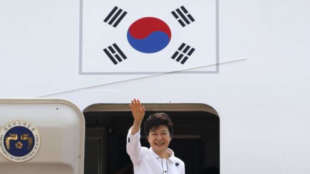 South Korean President Park Geun-hye waves as she embarks an airplane at the Seoul Air Base of South Korean air force in Seongnam, south of Seoul June 27, 2013, before she leaves for China.