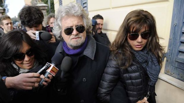 Poll time ... Grillo and his wife arrive to cast their votes at the polling station in Genoa.