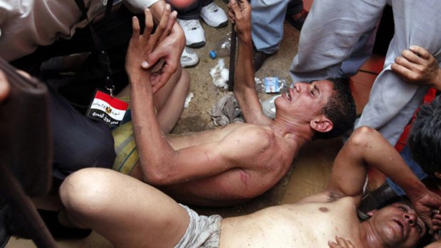Summary justice &#8230; two alleged attackers lay stripped and beaten by protesters in Cairo's Tahrir Square this week.