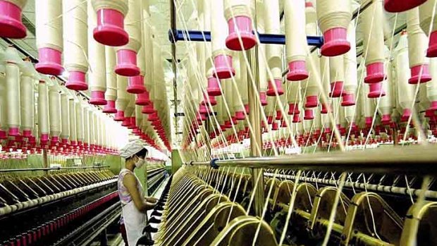 A labourer at a textile mill in China, where wages and conditions for factory workers are surging, putting pressure on prices.