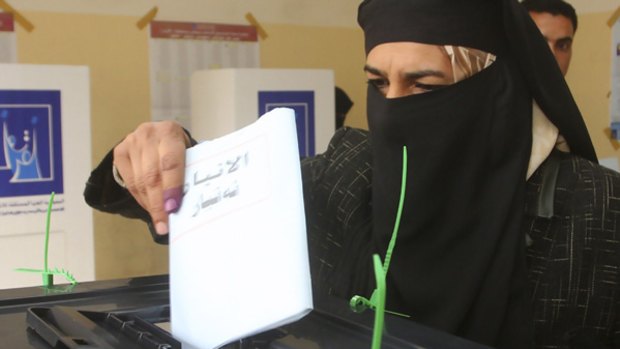 A Baghdad woman casts her vote.