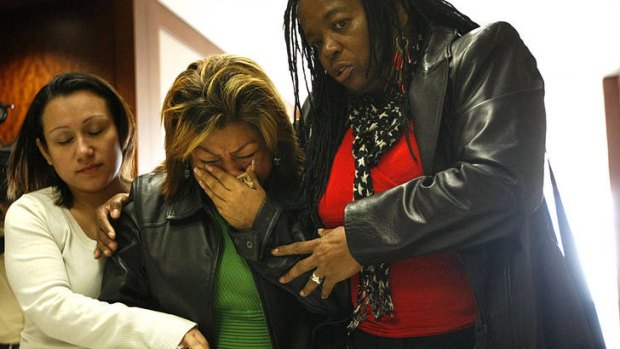 Rosie Castillo, centre, grandmother of 16-month-old day care fire victim Elias Castillo, is helped from the court during closing arguments.