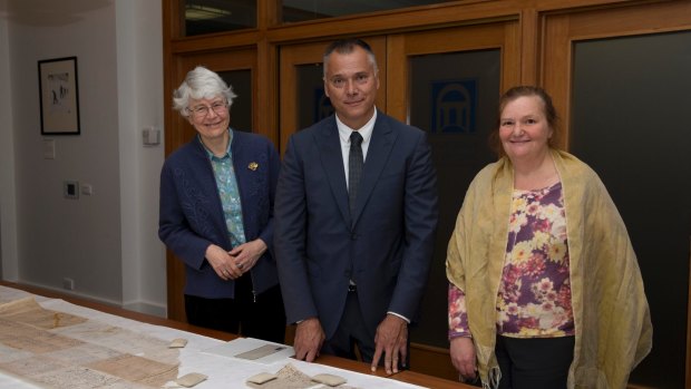 Hilary Rowell (left) with Stan Grant showing him the Larrakia petition, which calls for land rights and political representation for Aboriginal people, when he visited the National Archives last year. 
Also pictured is Rebecca Bateman who worked in the Indigenous Unit with Ms Rowell.

