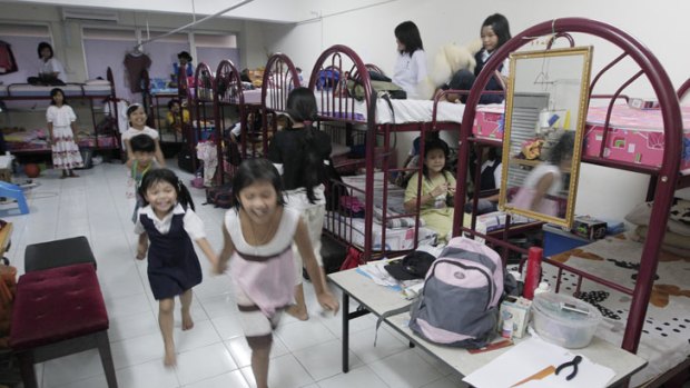 Refugee children from Myanmar play in their shared room in a suburb of Kuala Lumpur, Malaysia.