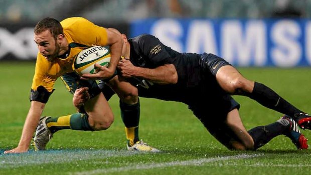 Hard debut: Halfback Nic White is tackled by the Puma?s Felipe Contepomi in the hard-fought Wallaby win.