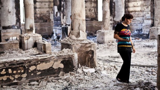 A Coptic woman inspects the damage to the Amir Tadros Church in Minya after it was set alight.