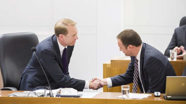 Simon Corbell shakes hands with Andrew Barr after introducing the Marriage Equality Bill in the ACT Legislative of Assembly.