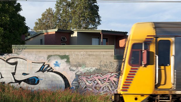 Graffiti covers a wall next to a train line at Enoggera, Brisbane, April 21, 2012.