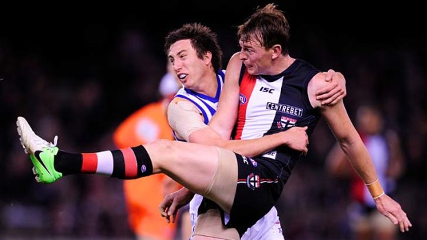 North's Sam Wright tackles Saint Brendon Goddard.