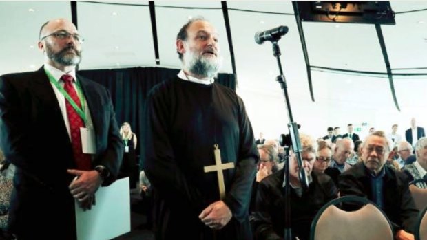 Activist shareholder Bruce Sheppard, dressed as a priest, told Sir Ralph Norris: "Your penance seems appropriate and your confession seems sort of complete."