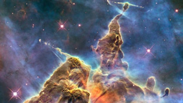 In focus ... a Hubble telescope image showing towers of cool hydrogen laced with dust rising from the wall of the Carina Nebula.