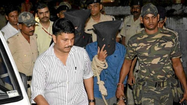 A hooded Yasin Bhatkal, accused of a string of bomb attacks in India, is taken to a court in Bihar.