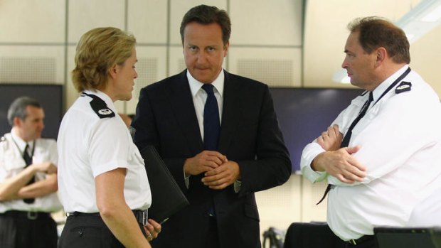 'Sick' ... PM David Cameron visits the West Midlands Police Events Control Suite.