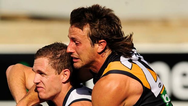 Richmond's Ivan Maric tackles Geelong's Joel Selwood.