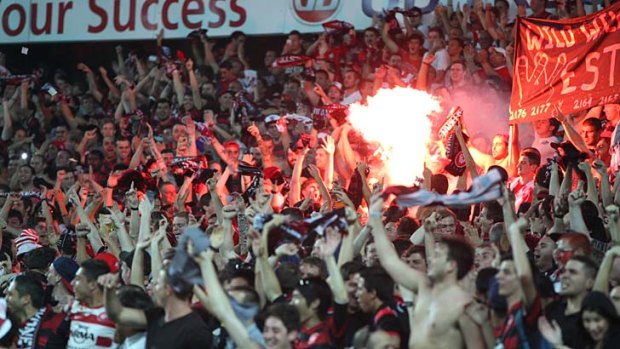 On fire ... Western Sydney Wanderers fans during the Sydney derby.
