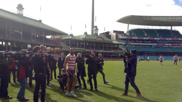 Welcome back: Adam Goodes makes his way through the media throng on to the Sydney Cricket Ground.
