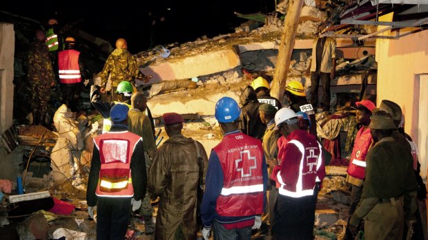 Kenya Red Cross personnel work at the site of a building collapse in Nairobi.