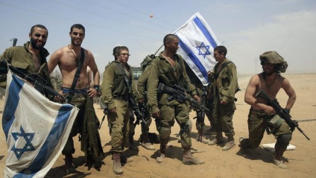 Back home: Israeli soldiers from the paratroop battalion return to Israel from Gaza on Monday.