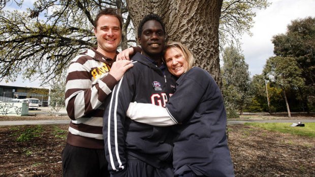 Gippsland Power under-18 player Anthony Tipungwuti with guardian Jane McDonald and her son Michael.