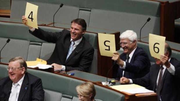 A touch of Australian idol...Independent MP's rate Craig Emerson's performance yesterday. Holding up cards are Robert Oakeshott, Bob Katter and Tony Windsor,