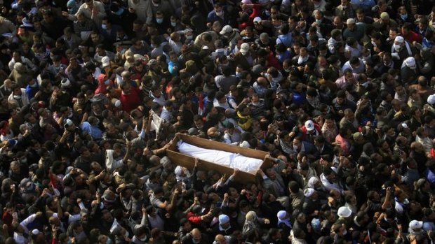 Egyptians carry a body of a protester, who was killed in recent clashes with the Egyptian riot police, during his funeral at Tahrir Square in Cairo.