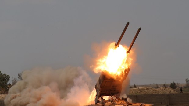 Iraqi security forces launch rockets against Islamic State extremist positions in Tikrit before taking the city.