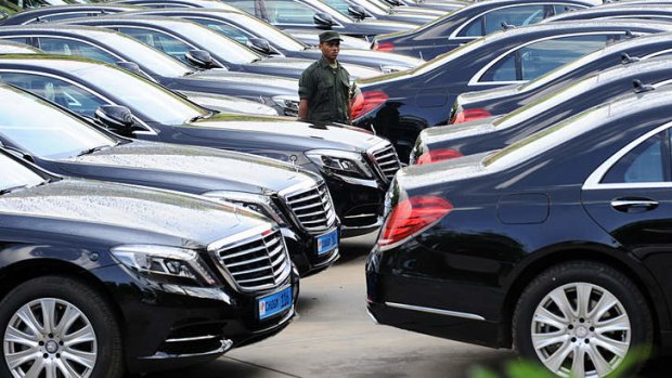 Power trip: A Sri Lankan soldier guards a fleet of new  Mercedes Benz cars that will be used by Commonwealth leaders at CHOGM.