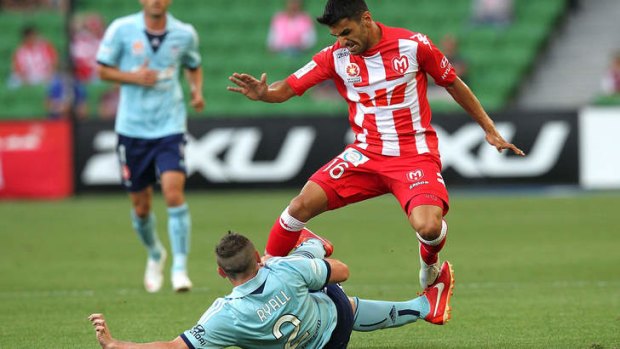 Crunch match: Sebastian Ryall tackles Aziz Behich during Sydney FC's loss to Melbourne Heart at AAMI Park on January 31.