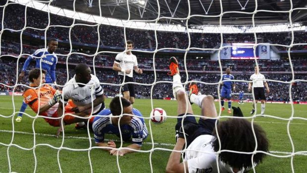 Chelsea and Tottenham Hotspur players block a shot from Chelsea's Juan Mata, which was controversially awarded as a goal, during their FA Cup semi-final in 2012.