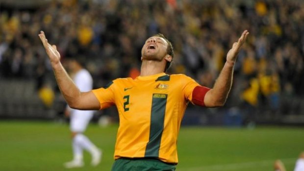 In happier times: Lucas Neill celebrates victory over Jordan in 2013 that took Australia to the brink of qualification for the 2015 World Cup.