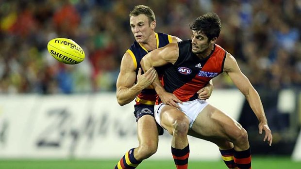 Brent Reilly of the Crows competes with David Myers of the Bombers.