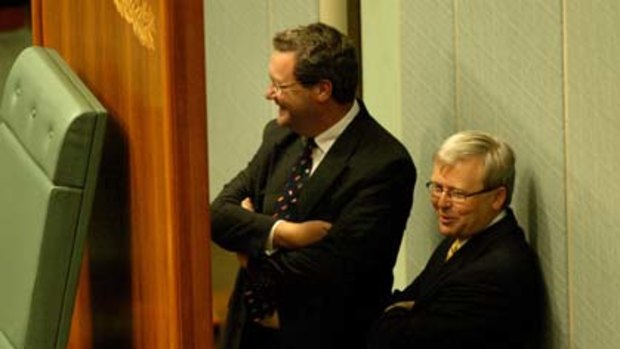 The then Foreign Affairs Minister, Alexander Downer, chats behind the speaker's chair in parliament with Kevin Rudd, then shadow foreign affairs spokesman.