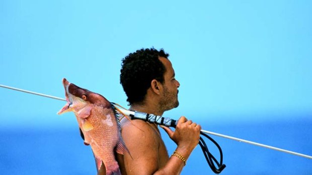 A Belize fisherman well practised with a speargun.