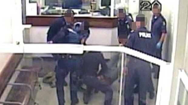 A CCTV image shows police crowding around Kevin Spratt, who was Tasered multiple times.