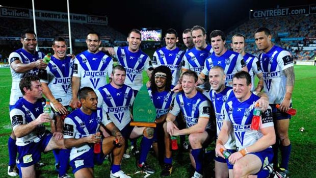 The Bulldogs pose with the reconciliation trophy after beating the North Queensland Cowboys at Dairy Farmers Stadium.