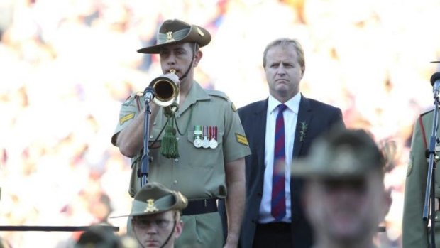 Lest we forget: NRL boss Dave Smith watches on as the Last Post is played before the NRL Anzac Day clash in 2013.
