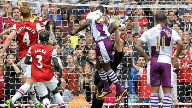Aston Villa's Christian Benteke (centre) heads to score a penalty rebound against Arsenal during their English Premier League soccer match at Emirates Stadium in London.