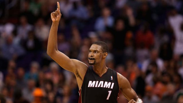 Miami Heat forward Chris Bosh reacts after hitting a three-point shot against the Phoenix Suns.