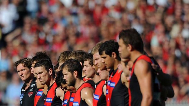 The Essendon team during the minute's silence.