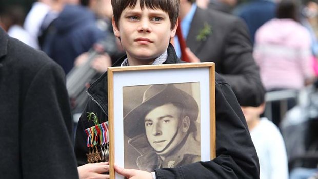 Marching for those who can't...Simon Colagiuri  holds a photo of his great grandad, Robert Lumsdaine, who served in WW2.