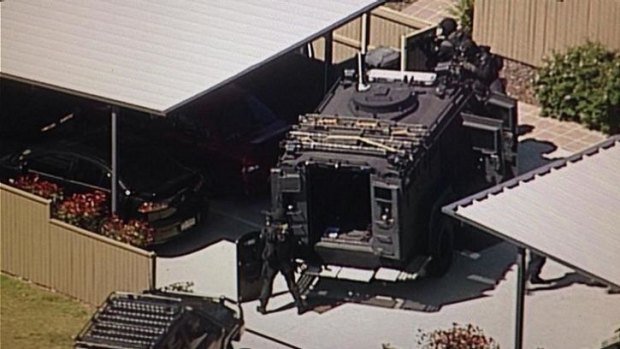 SERT officers at the scene of the seige at Inala. Photo: Jess Millward/Nine News