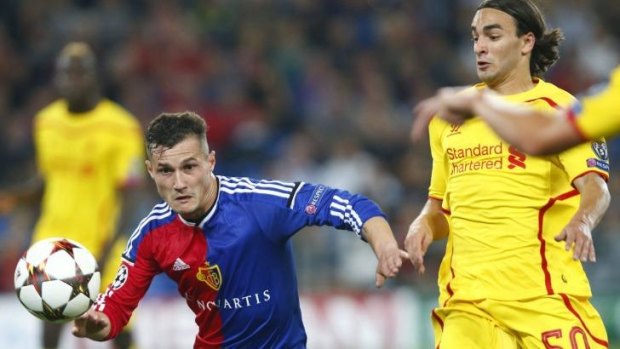 FC Basel's Taulant Xhaka (left) fights for the ball with Liverpool's Lazar Markovic.