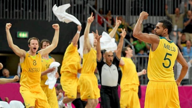 Patrick Mills of Australia celebrates after making the game-winning three point shot against Russia in the final seconds of the Men's Basketball Preliminary Round match at the London Olympics.