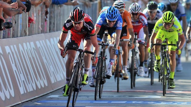 Cadel Evans leads defending champion Ryder Hesjedal of Canada over the line to claim valuable time bonuses.
